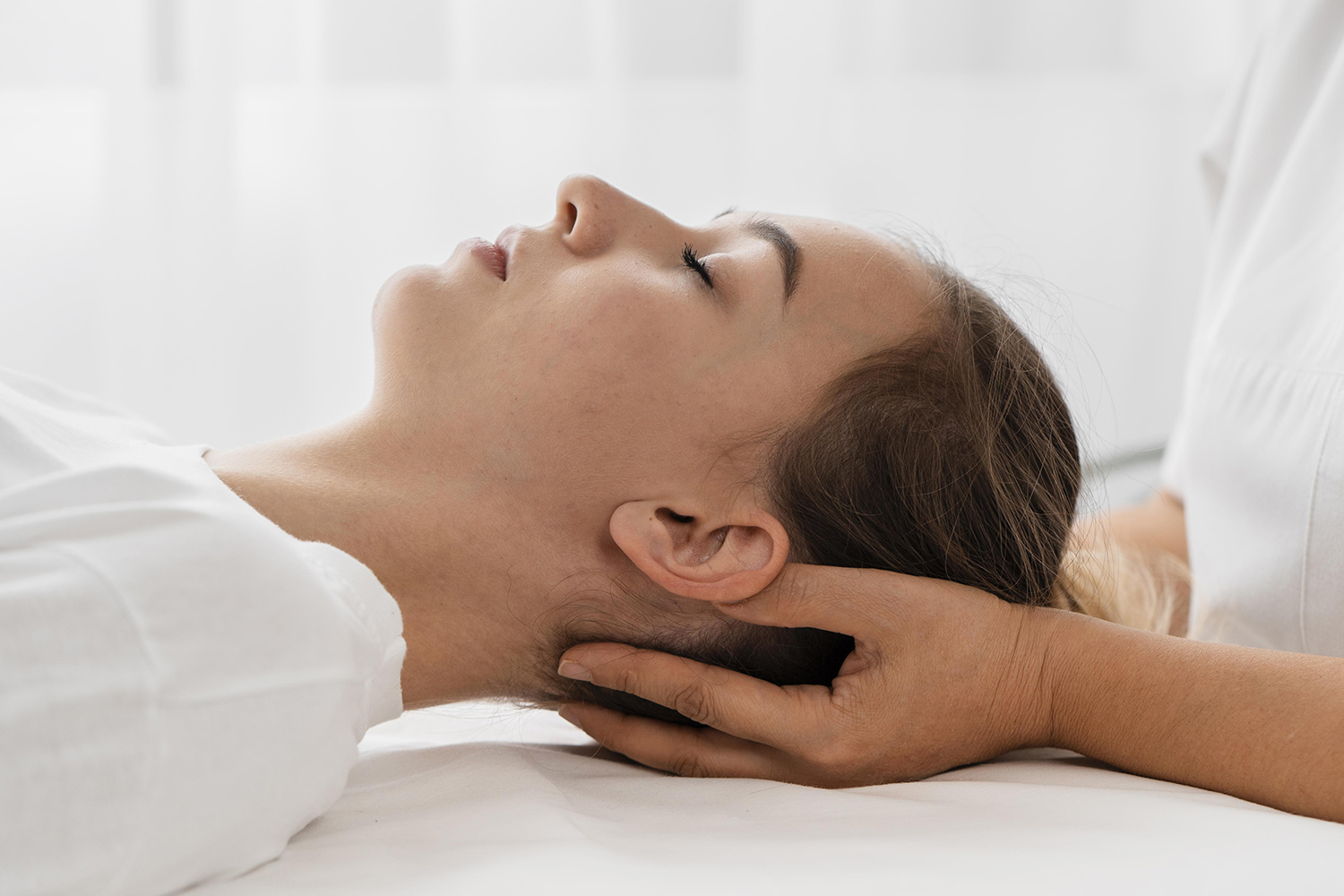 professional female physiotherapist giving shoulder massage to blonde woman